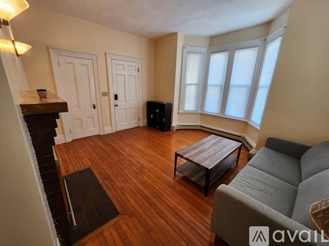 A living room with a grey couch and a wooden coffee table.