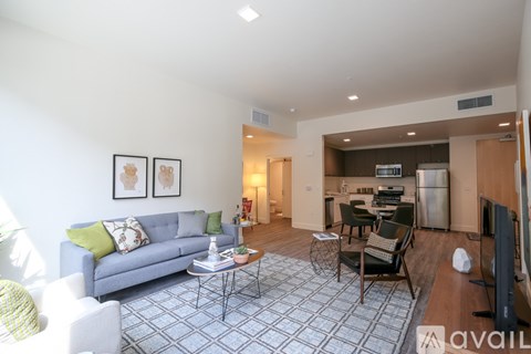 A living room with a grey couch and a coffee table.