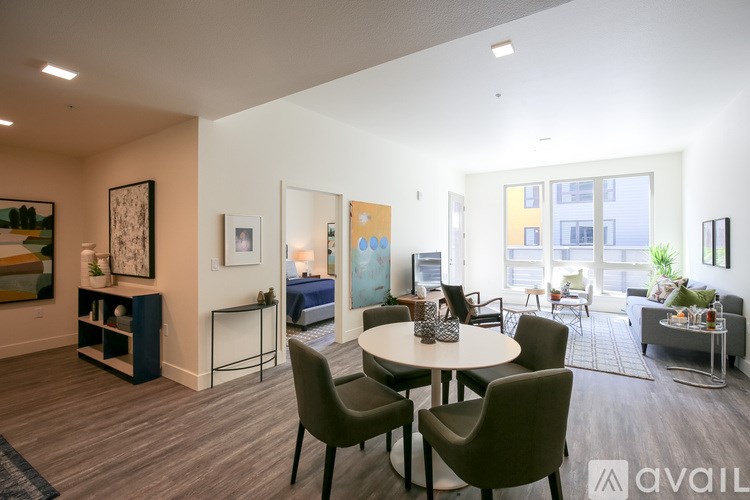 A living room with a round table and chairs.