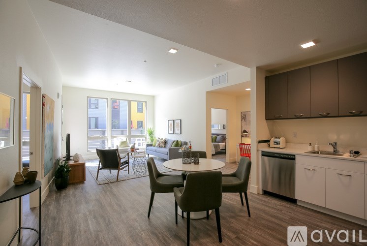 A living room with a dining table and chairs.