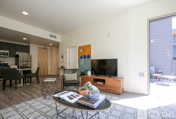 A living room with a black table and a television.