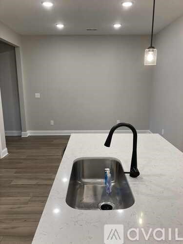 A kitchen with a sink and a modern faucet.