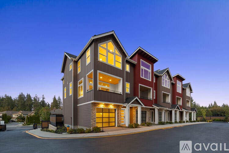 A modern two-story building with a large front yard is available for purchase.