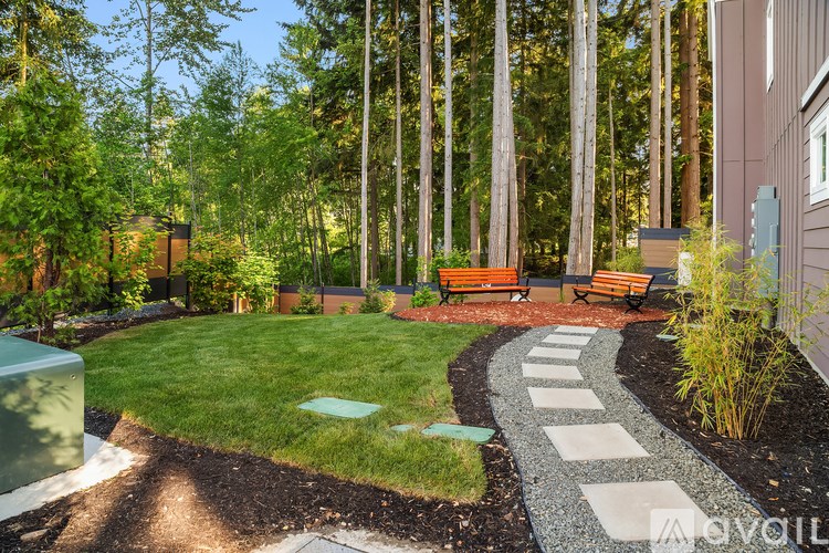 A garden with a gravel path and benches.