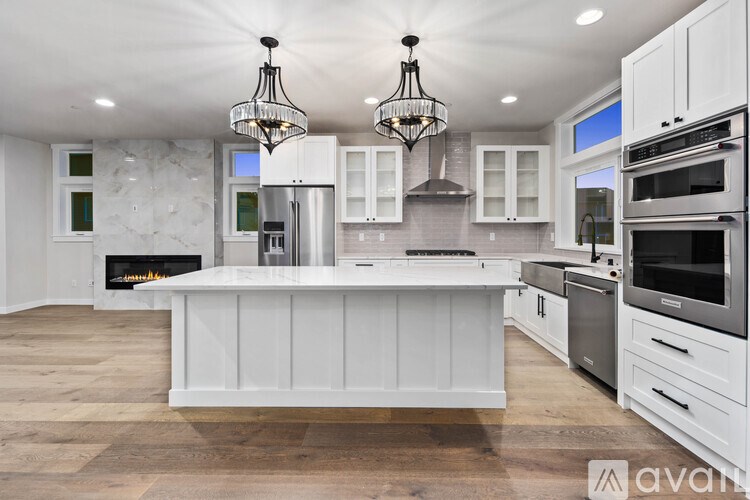 A modern kitchen with a large island and stainless steel appliances.
