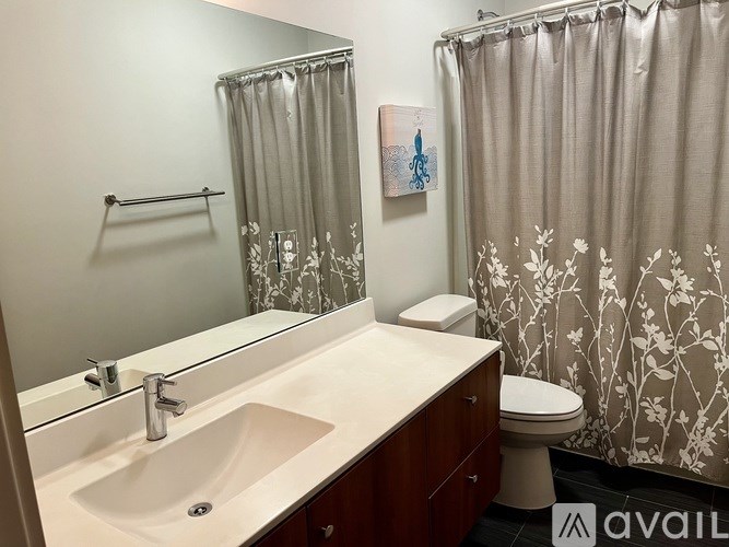 A bathroom with a white sink and a toilet.