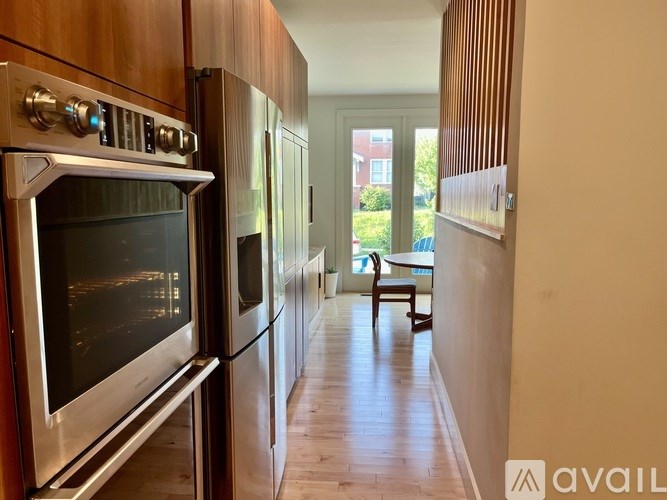 A kitchen with a stainless steel oven and refrigerator.