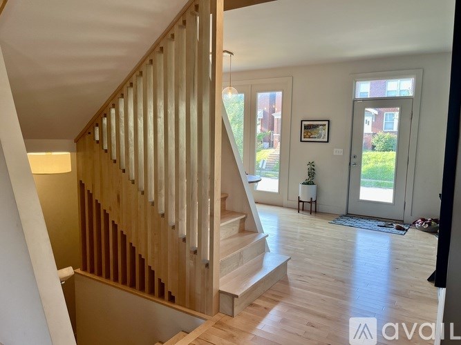 A wooden staircase with a light on the side.