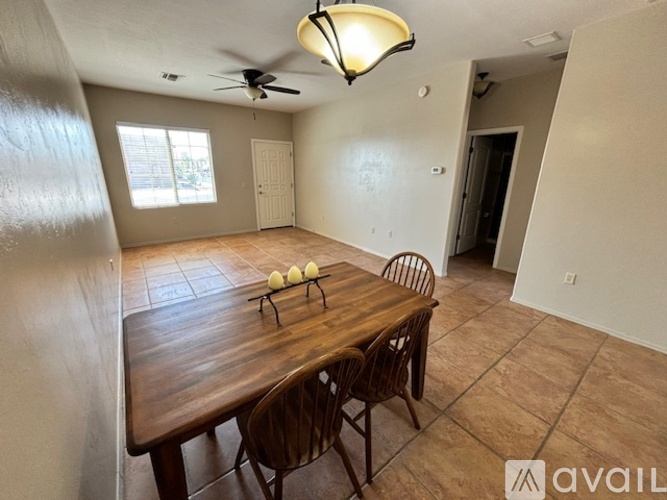 A dining room with a wooden table and chairs.