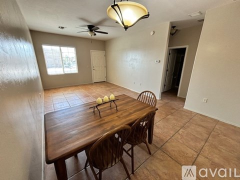 A dining room with a wooden table and chairs.