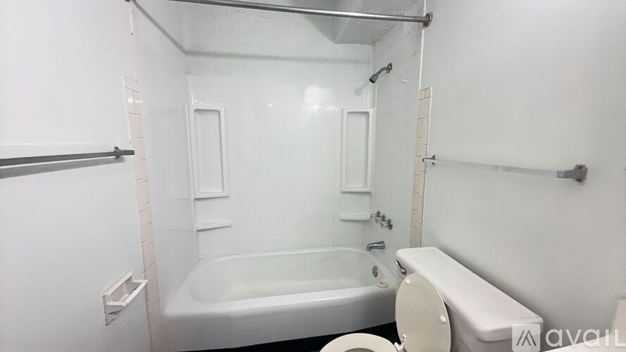 A white bathroom with a bathtub, toilet, and sink.