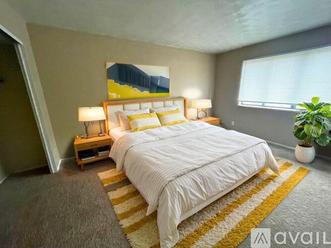 A room with a white door and a grey wall.