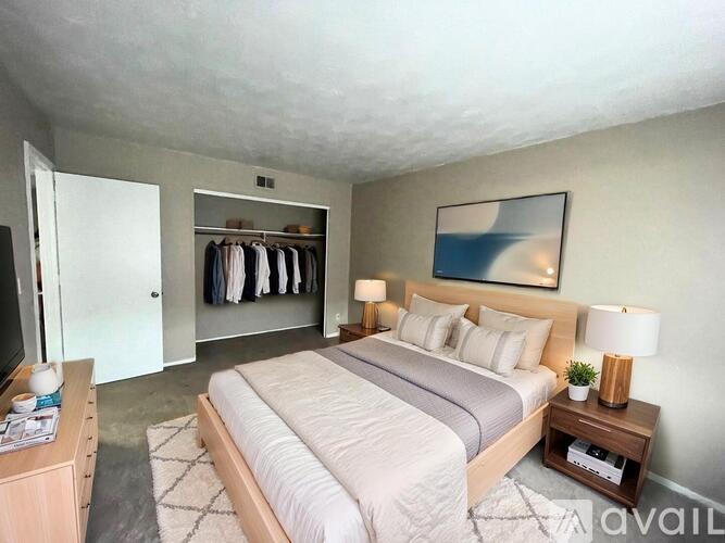 A room with a carpeted floor and a window with blinds.