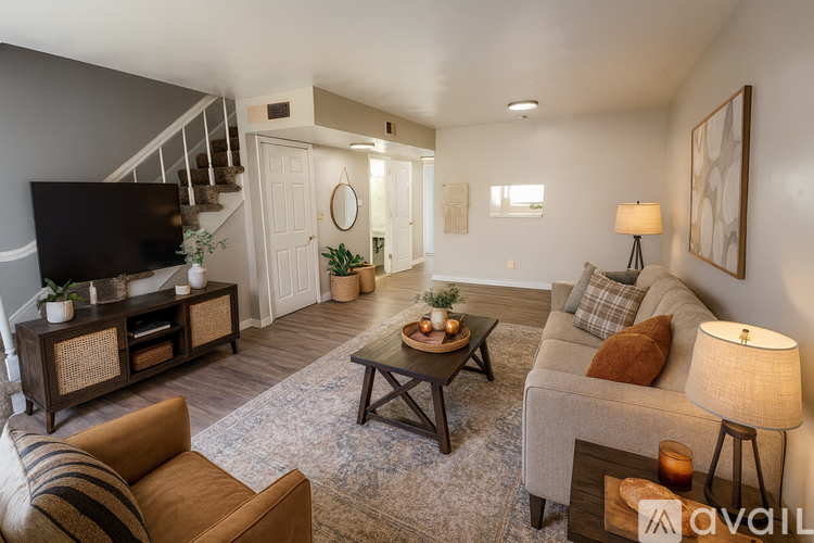 A room with a carpeted floor and a white door.