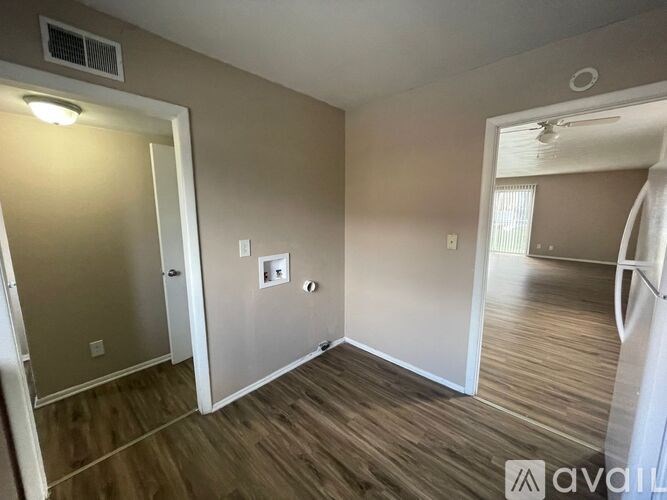 A room with wooden floors and a white door.