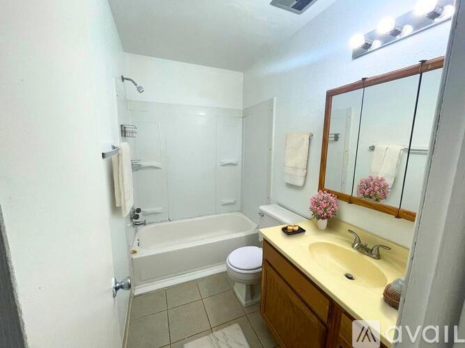 A room with carpeted floor and four doors.