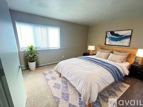 A carpeted room with a window and a door.
