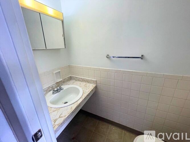 A small white toilet in a small bathroom.