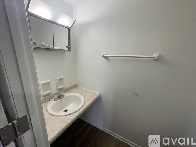 A bathroom with a sink and a towel bar.