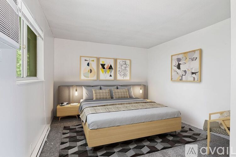 A bedroom with a bed, nightstands, and pictures on the wall.