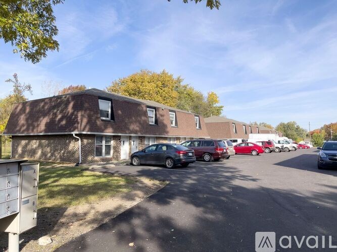 A parking lot with cars and a building in the background.