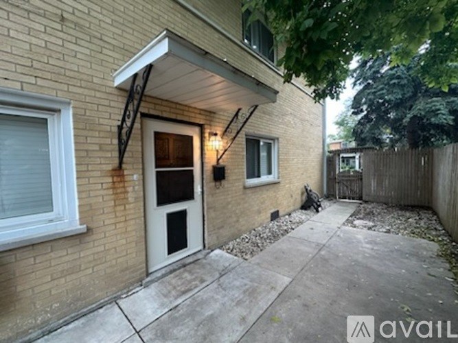 A house with a white door and a window with a black frame.