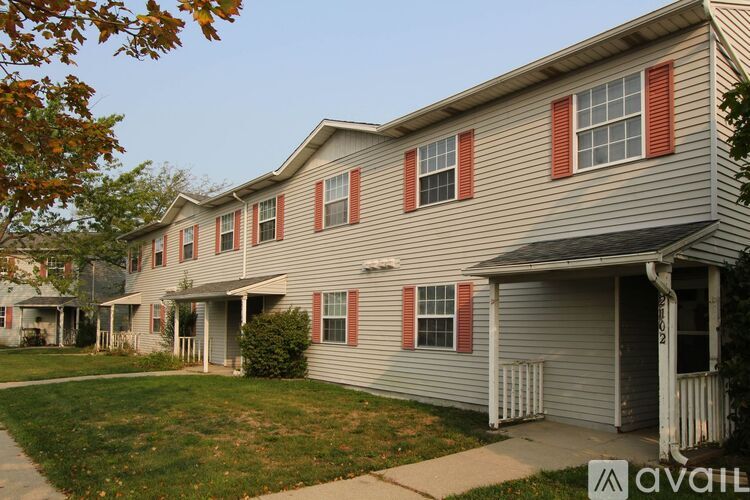 A row of houses with the front of the first one visible.