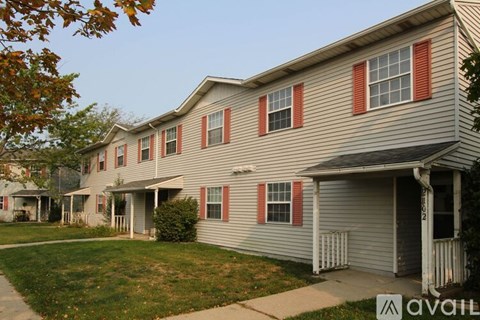 A row of houses with the front of the first one visible.
