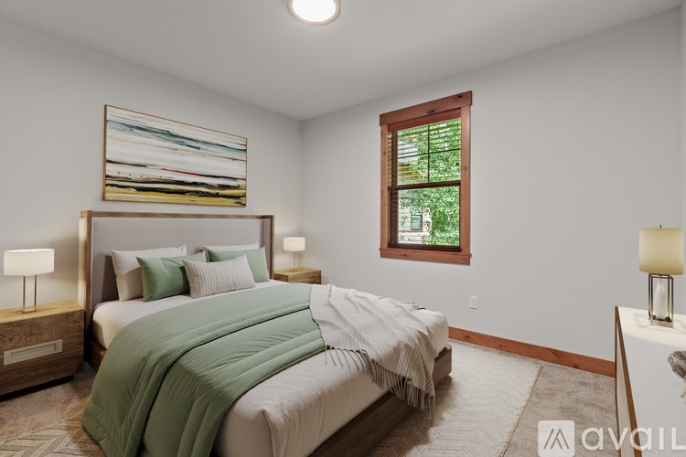 A bedroom with a large bed and a window.