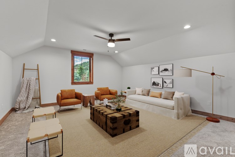 A living room with a white couch, orange chairs, and a wooden coffee table.