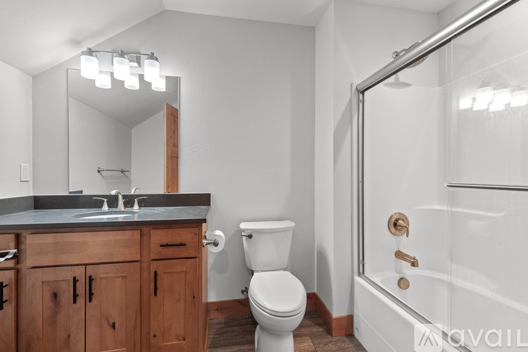 A bathroom with a toilet, sink, and shower.