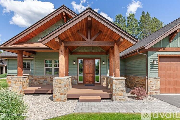 A house with a wooden front porch and a brown door.
