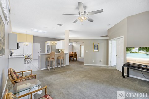 A living room with a television and a glass table.