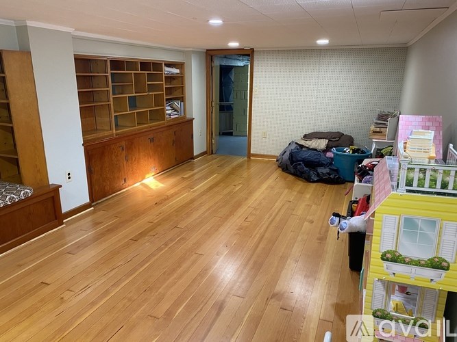 A room with wooden floors and a green door.