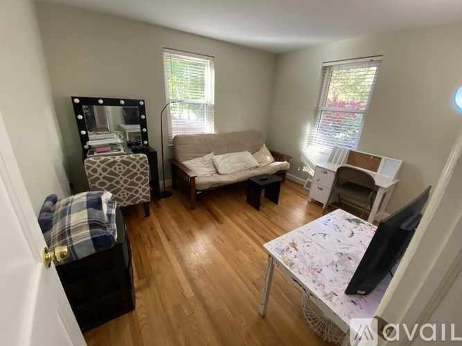 A living room with a couch, chair, and television.
