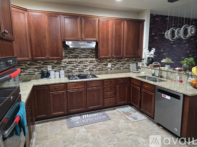 A kitchen with wooden cabinets and a stone backsplash.