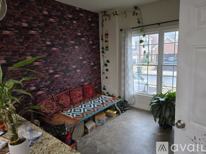 A room with a brick wall and a bench.