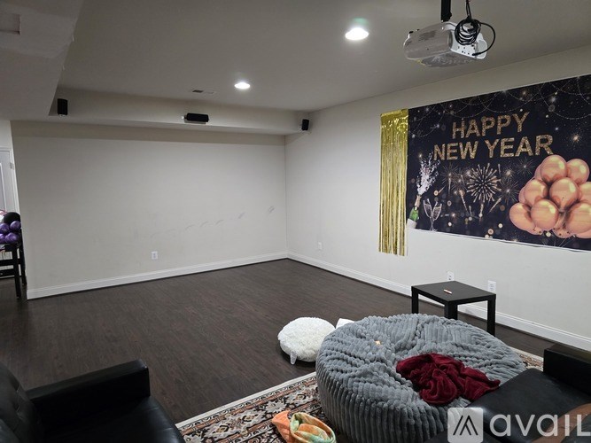 A room with a New Year's themed poster on the wall.