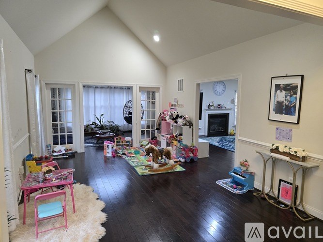 A living room with a fireplace and a picture on the wall.