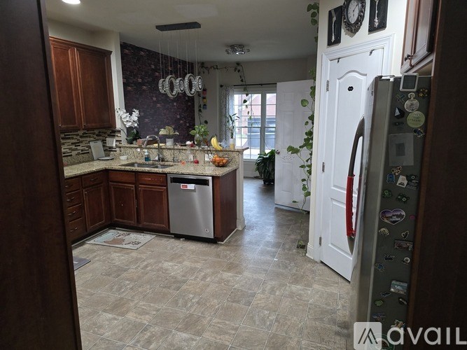 A kitchen with a refrigerator covered in magnets.