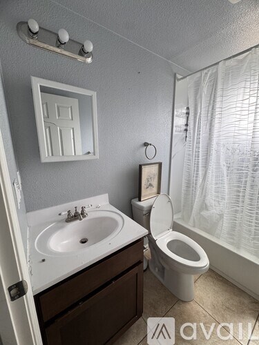 A white toilet sits next to a sink in a bathroom.