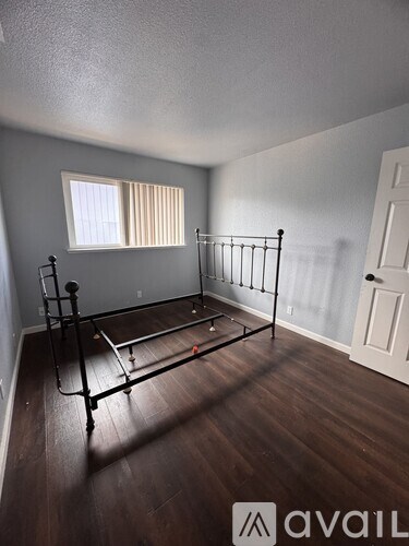 A room with a bed frame in it.
