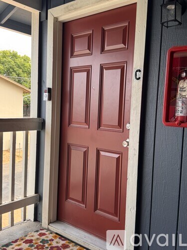 A red door with a glass window is open.