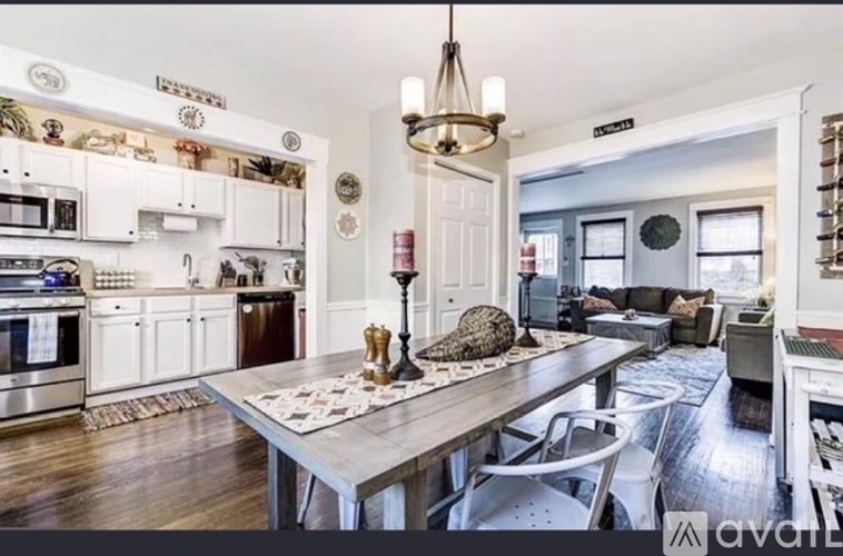 A kitchen with a table and chairs in the middle of the room.