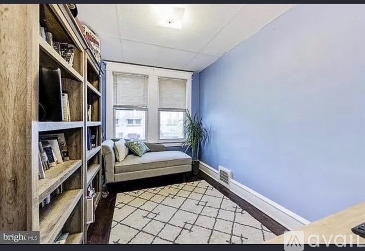 A room with a bed, a window, and a bookshelf.