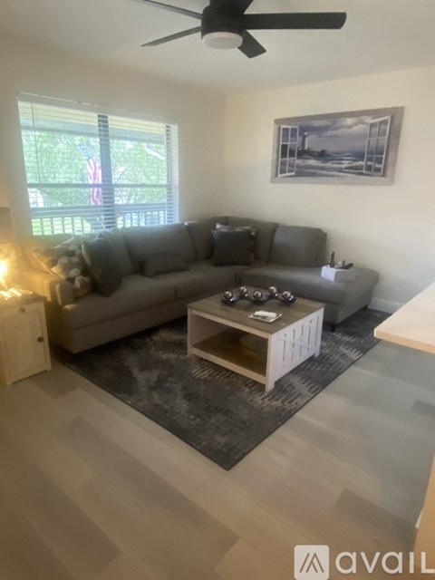 A living room with a grey sofa and a coffee table.