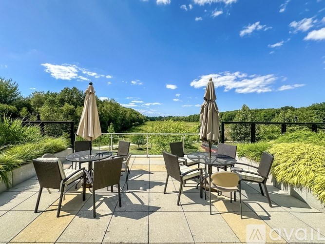 A patio with chairs and tables is set up for outdoor dining.