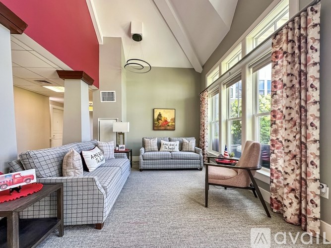A living room with a grey couch and a red sofa.