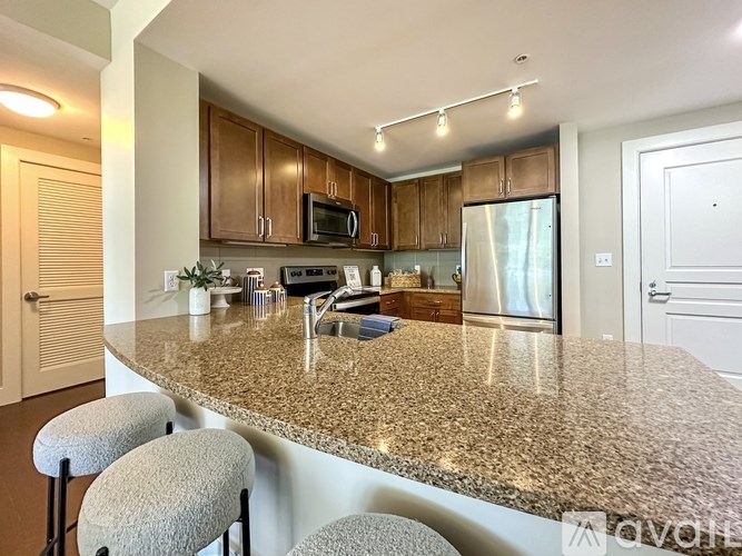 A kitchen with granite countertops and stainless steel appliances.