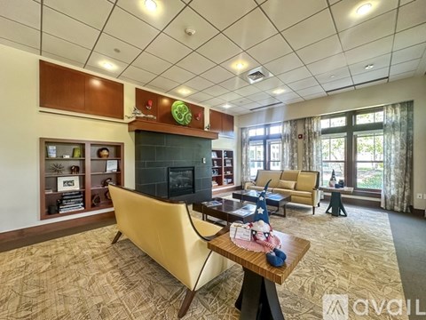 A living room with a yellow sofa and a wooden coffee table.